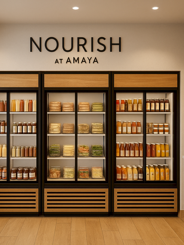 This image shows a modern grocery store section with fridges, shelves of packaged goods, and a coffee machine with microwave nearby.