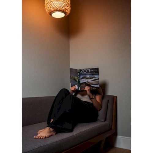 Guest reading Zen Gardens on lounge sofa
