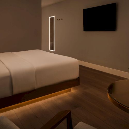 Guest room at The Amaya at night, featuring soft ambient lighting and a calm, minimalist interior